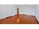 Cozy bedroom featuring hardwood floors and multiple access doors at 1633 Corner Meadow Cir, Orlando, FL 32820