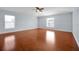 Bright bedroom with wood floors, neutral walls, and two windows at 1633 Corner Meadow Cir, Orlando, FL 32820