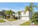 Two-story house with a green door and attached garage, and palm trees at 1633 Corner Meadow Cir, Orlando, FL 32820