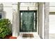 Green front door with glass panels and a welcome mat at 1633 Corner Meadow Cir, Orlando, FL 32820