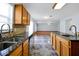 Kitchen features granite countertops, dual sinks, and ample wood cabinets at 1633 Corner Meadow Cir, Orlando, FL 32820