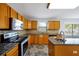 Kitchen with wood cabinets, granite countertops, and stainless steel appliances at 1633 Corner Meadow Cir, Orlando, FL 32820