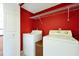 Cozy laundry room with washer, dryer, and wire rack shelving at 1633 Corner Meadow Cir, Orlando, FL 32820