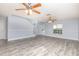 Open-concept living room with hard surface floors, ceiling fans, and soaring ceilings at 1633 Corner Meadow Cir, Orlando, FL 32820