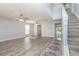 Living room with hard surface floors, ceiling fans, and stairway at 1633 Corner Meadow Cir, Orlando, FL 32820