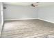 Expansive living room featuring plank flooring, neutral walls, and large windows for ample natural light at 1633 Corner Meadow Cir, Orlando, FL 32820