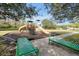 Community playground featuring slides, climbing structures, and benches with green trim at 1633 Corner Meadow Cir, Orlando, FL 32820