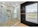 Large walk-in shower with marble tile and built-in seat at 1633 Corner Meadow Cir, Orlando, FL 32820