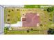 Aerial view of a house with a brown roof, surrounded by a well-maintained green lawn and a concrete driveway at 1719 North W Blvd, Davenport, FL 33837