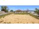 Large backyard with mostly sandy open area and a fence surrounding it at 1719 North W Blvd, Davenport, FL 33837