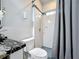 Bathroom featuring granite counters, tiled shower and a neutral color scheme at 1719 North W Blvd, Davenport, FL 33837