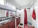 Bathroom features a granite topped vanity, double sinks, decorative mirrors, and a walk-in shower at 1719 North W Blvd, Davenport, FL 33837