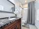 Modern bathroom with dark granite vanity and walk-in shower at 1719 North W Blvd, Davenport, FL 33837