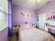 Serene bedroom with a double bed, desk, and purple walls at 1719 North W Blvd, Davenport, FL 33837