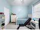 This is a blue bedroom with a bed, a dresser, and a workout bench at 1719 North W Blvd, Davenport, FL 33837