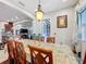Elegant dining room with a table for six and view into kitchen at 1719 North W Blvd, Davenport, FL 33837