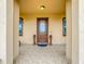 Front entry with tiled flooring, decorative urns, and a wood door at 1719 North W Blvd, Davenport, FL 33837