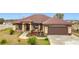 House exterior showcasing a brown roof, light beige siding, and a brown garage door at 1719 North W Blvd, Davenport, FL 33837