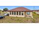 Tan house exterior with a brown roof and sunroom addition at 1719 North W Blvd, Davenport, FL 33837