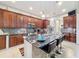 Kitchen with dark wood cabinets, granite countertops, and an island at 1719 North W Blvd, Davenport, FL 33837