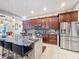 Bright kitchen with stainless appliances, granite counters, island with bar seating, and ample storage at 1719 North W Blvd, Davenport, FL 33837