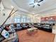 Living room showcasing a sectional sofa, ceiling fan, and large windows at 1719 North W Blvd, Davenport, FL 33837