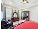 This main bedroom features an accent chair, tile floors, recessed lights, and an ornate headboard at 1719 North W Blvd, Davenport, FL 33837