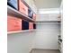 This organized walk-in closet includes built-in shelving for storage and ample lighting at 1719 North W Blvd, Davenport, FL 33837
