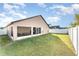 Spacious backyard with screened patio and grassy area at 2463 Hybrid Dr, Kissimmee, FL 34758