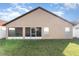 House backyard with screened patio and grassy area at 2463 Hybrid Dr, Kissimmee, FL 34758