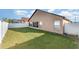 Large backyard with grassy area and white fence at 2463 Hybrid Dr, Kissimmee, FL 34758