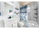 Clean bathroom with tub shower, white vanity, and beach theme at 2463 Hybrid Dr, Kissimmee, FL 34758