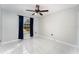 Spacious bedroom with tile floors and blue curtains at 2463 Hybrid Dr, Kissimmee, FL 34758