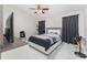 Spacious bedroom with ceiling fan and large TV at 2463 Hybrid Dr, Kissimmee, FL 34758