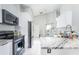Bright kitchen boasts granite countertops and modern appliances at 2463 Hybrid Dr, Kissimmee, FL 34758