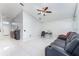 Living room with tile floors, sectional sofa, and ceiling fan at 2463 Hybrid Dr, Kissimmee, FL 34758
