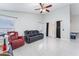 Living room with tile floors, sectional sofa, and ceiling fan at 2463 Hybrid Dr, Kissimmee, FL 34758
