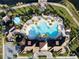 Aerial view of community pool, clubhouse, and surrounding landscape at 2516 Nouveau Way, Kissimmee, FL 34741