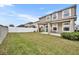Spacious backyard with grassy area and covered patio at 2516 Nouveau Way, Kissimmee, FL 34741