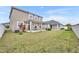 Large backyard with grassy lawn, privacy fence, and home view at 2516 Nouveau Way, Kissimmee, FL 34741