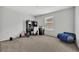 Bright bedroom with carpeted floor, window, and built-in desk at 2516 Nouveau Way, Kissimmee, FL 34741