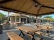 Outdoor picnic area with shaded tables and seating near the pool at 2516 Nouveau Way, Kissimmee, FL 34741