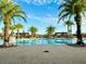 Relaxing community pool with palm trees and brick patio at 2516 Nouveau Way, Kissimmee, FL 34741