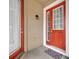 Red front door with glass panels and welcome mat at 2516 Nouveau Way, Kissimmee, FL 34741