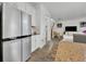 Stainless steel refrigerator and view into adjacent living area at 2516 Nouveau Way, Kissimmee, FL 34741