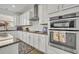 White shaker cabinets, granite countertops, and stainless steel appliances at 2516 Nouveau Way, Kissimmee, FL 34741