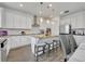 Kitchen with white cabinets, island, and stainless steel appliances at 2516 Nouveau Way, Kissimmee, FL 34741