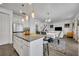 Open concept kitchen with island and view into living area at 2516 Nouveau Way, Kissimmee, FL 34741
