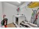 Laundry room with washer, dryer, and shelving for storage at 2516 Nouveau Way, Kissimmee, FL 34741