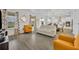 Living room with off-white sofa and mustard armchairs at 2516 Nouveau Way, Kissimmee, FL 34741